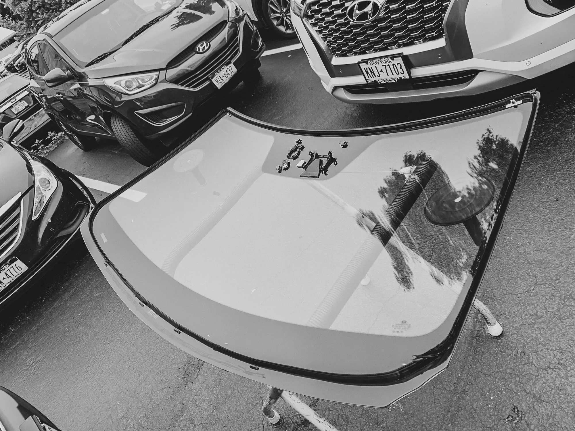 Newburgh Auto Glass shop with a replacement windshield staged on a stand