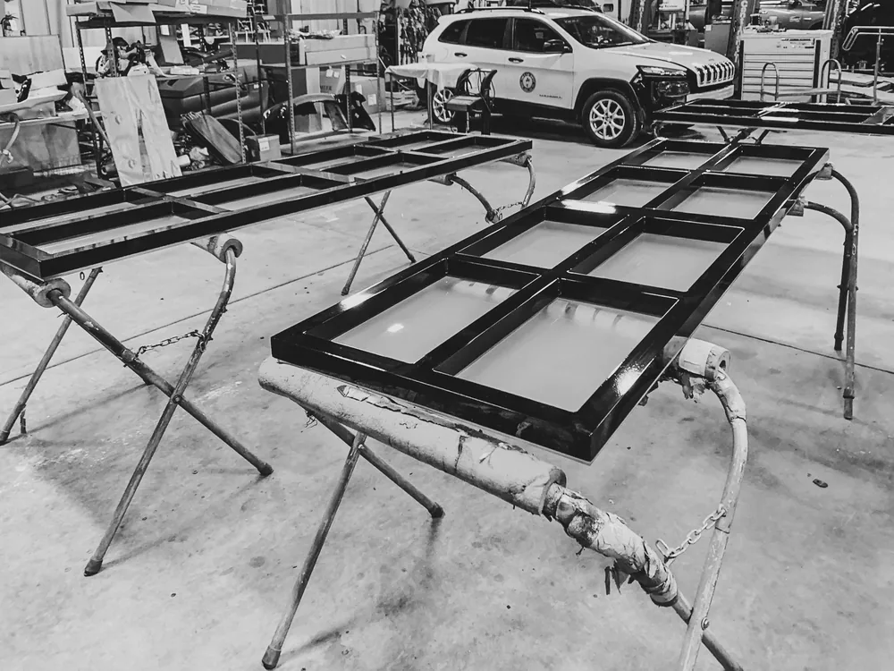 Windshield frames staged on stands inside the Newburgh Auto Glass shop