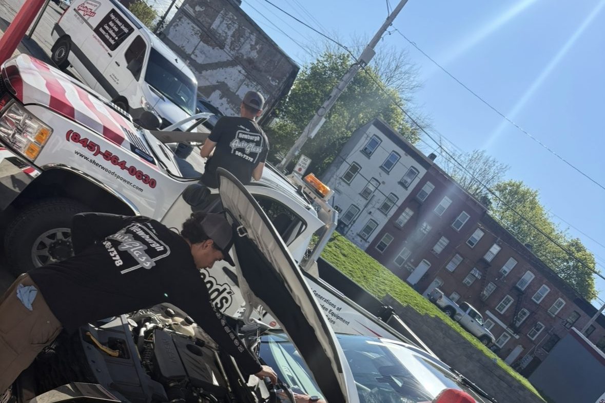 Newburgh Auto Glass technician servicing a pickup truck windshield