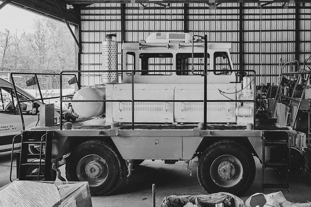 Military utility vehicle awaiting glass replacement in a Newburgh Auto Glass bay