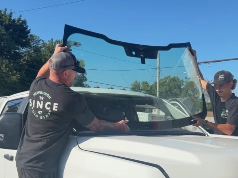 Newburgh Auto Glass technician replacing a windshield on a Ford Super Duty truck